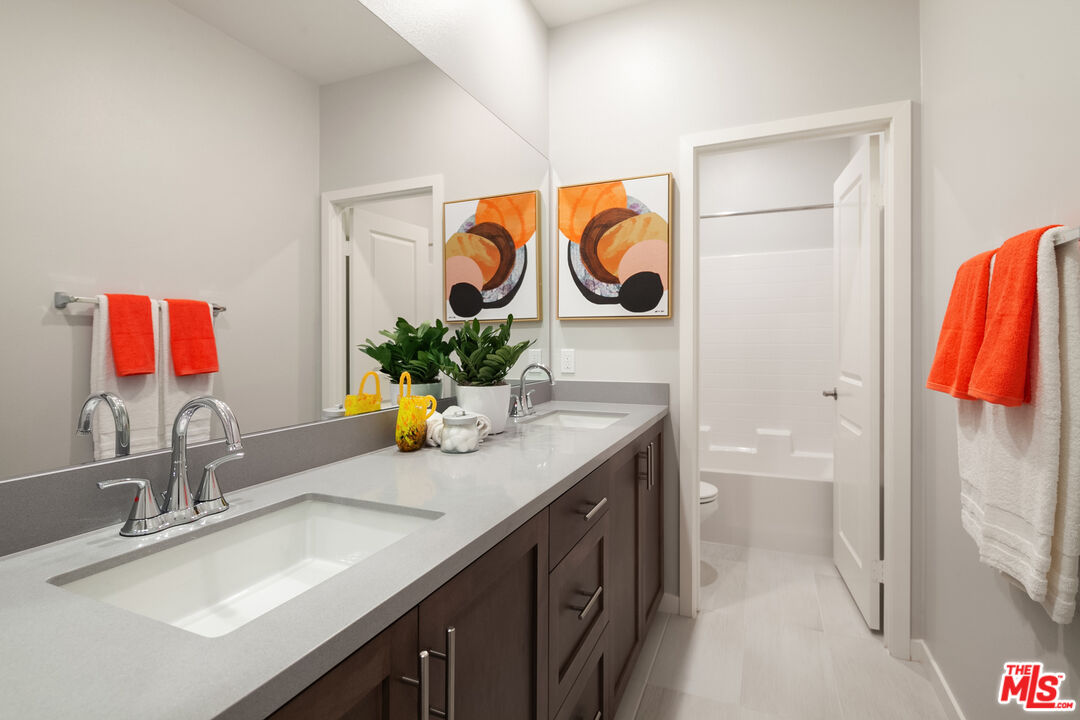 154 Tarragon Way Upland, CA 91786 - Photo 12 of 21 a bathroom with a sink a toilet and a mirror