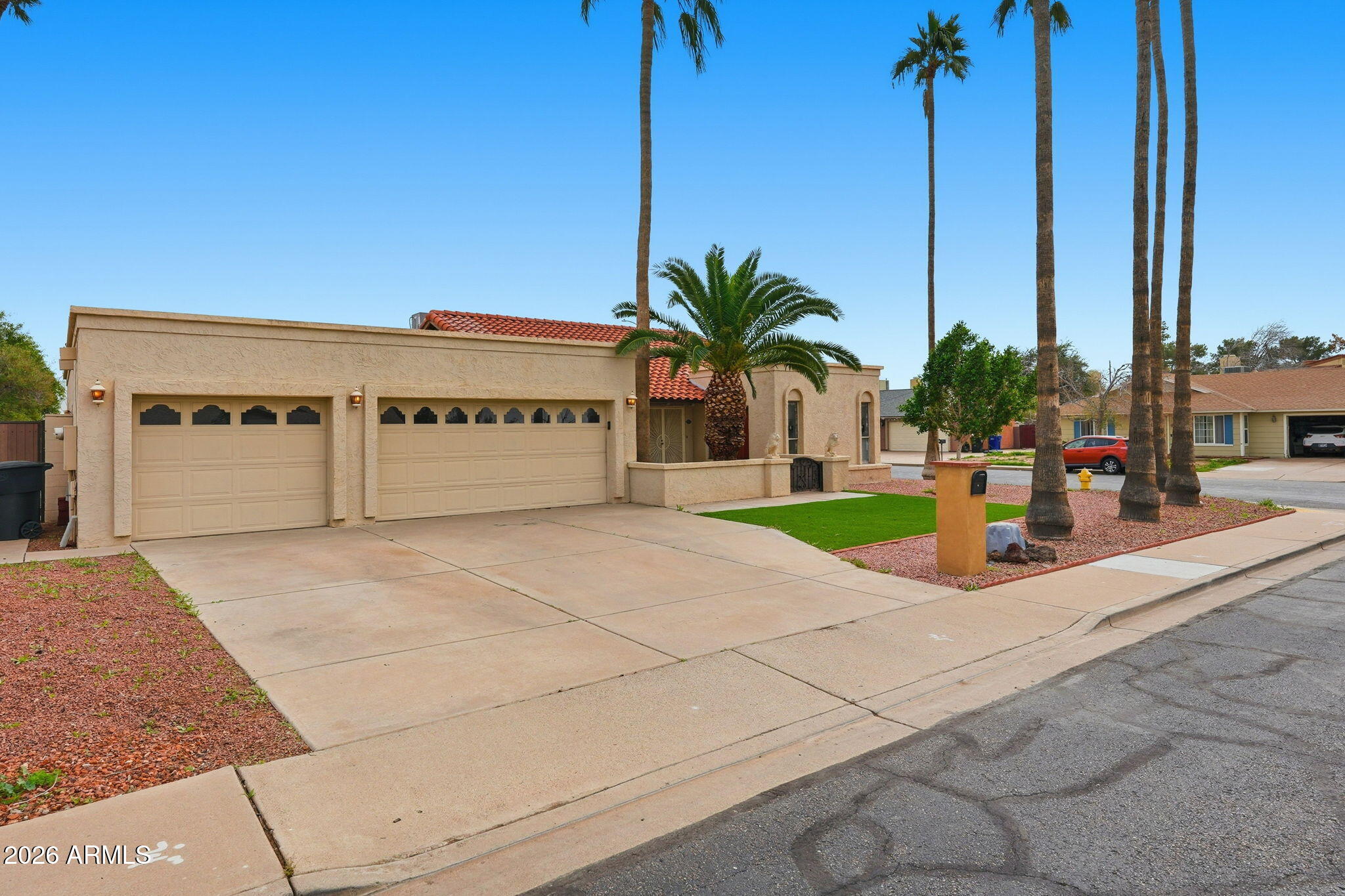 1305 North Spring Circle Mesa, AZ 85203 - Photo 1 of 28 a building with palm tree in front of it