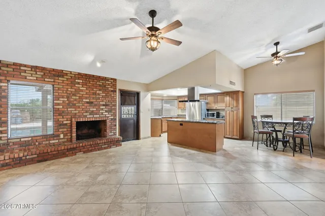 a living room with furniture a fireplace and a chandelier