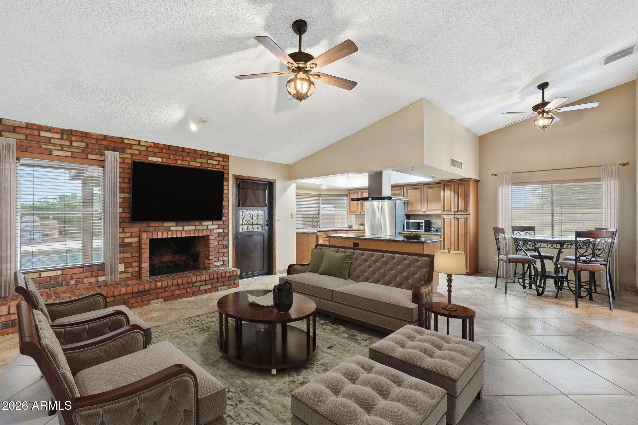 1305 North Spring Circle Mesa, AZ 85203 - Photo 11 of 28 a living room with furniture a fireplace and a flat screen tv