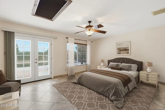 a spacious bedroom with a large bed and a window