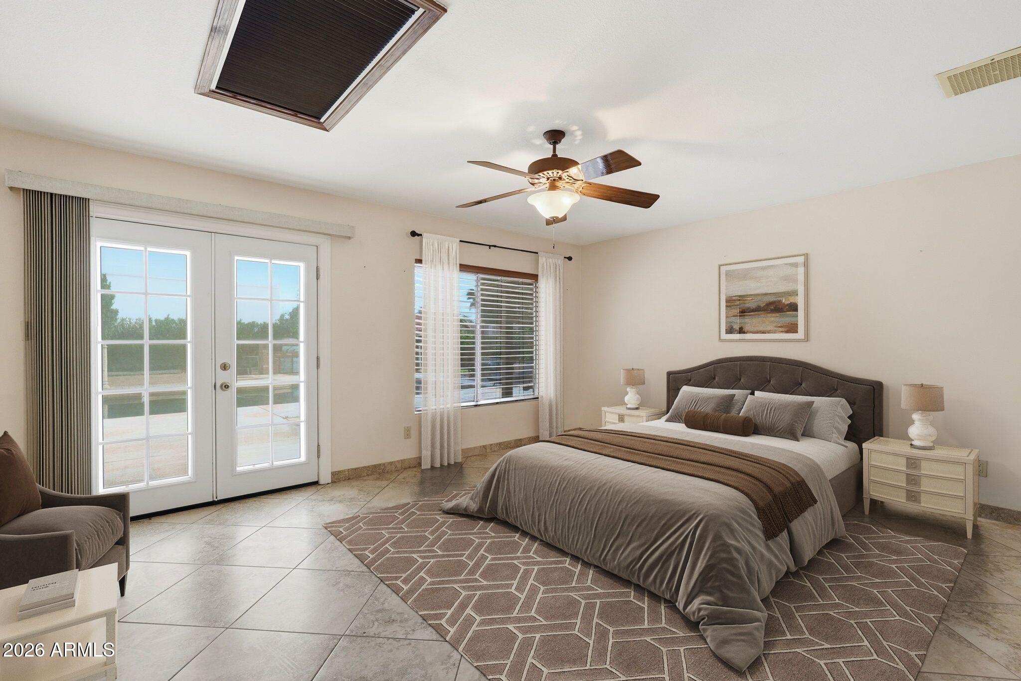 1305 North Spring Circle Mesa, AZ 85203 - Photo 13 of 28 a spacious bedroom with a large bed and a window