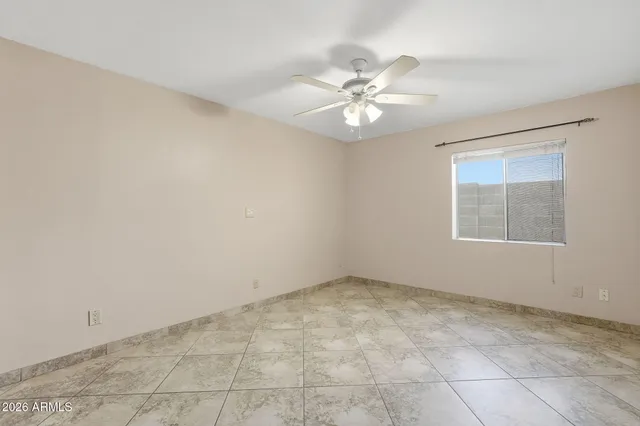 a view of an empty room with a ceiling fan