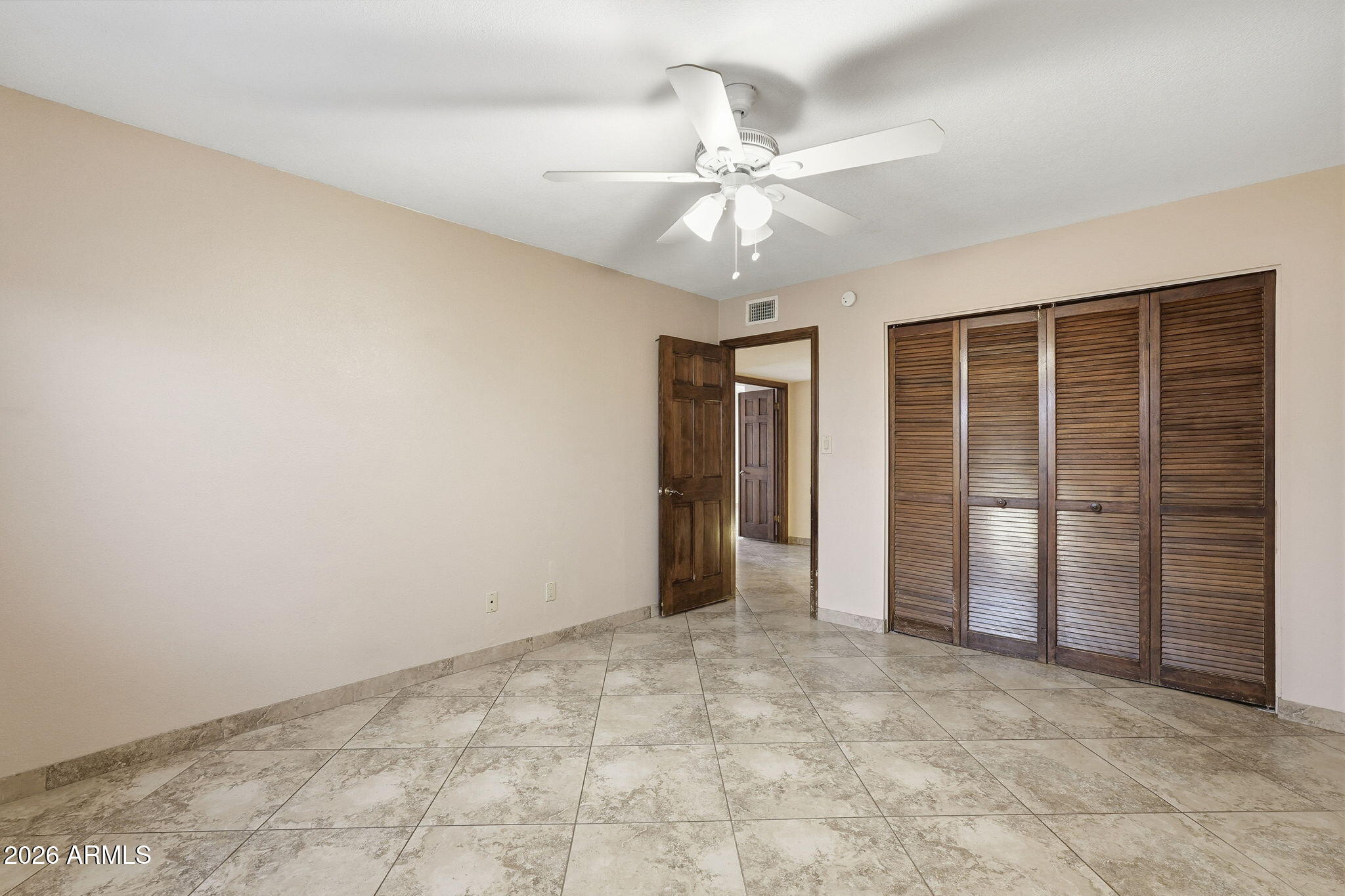 1305 North Spring Circle Mesa, AZ 85203 - Photo 20 of 28 a view of an empty room with a ceiling fan