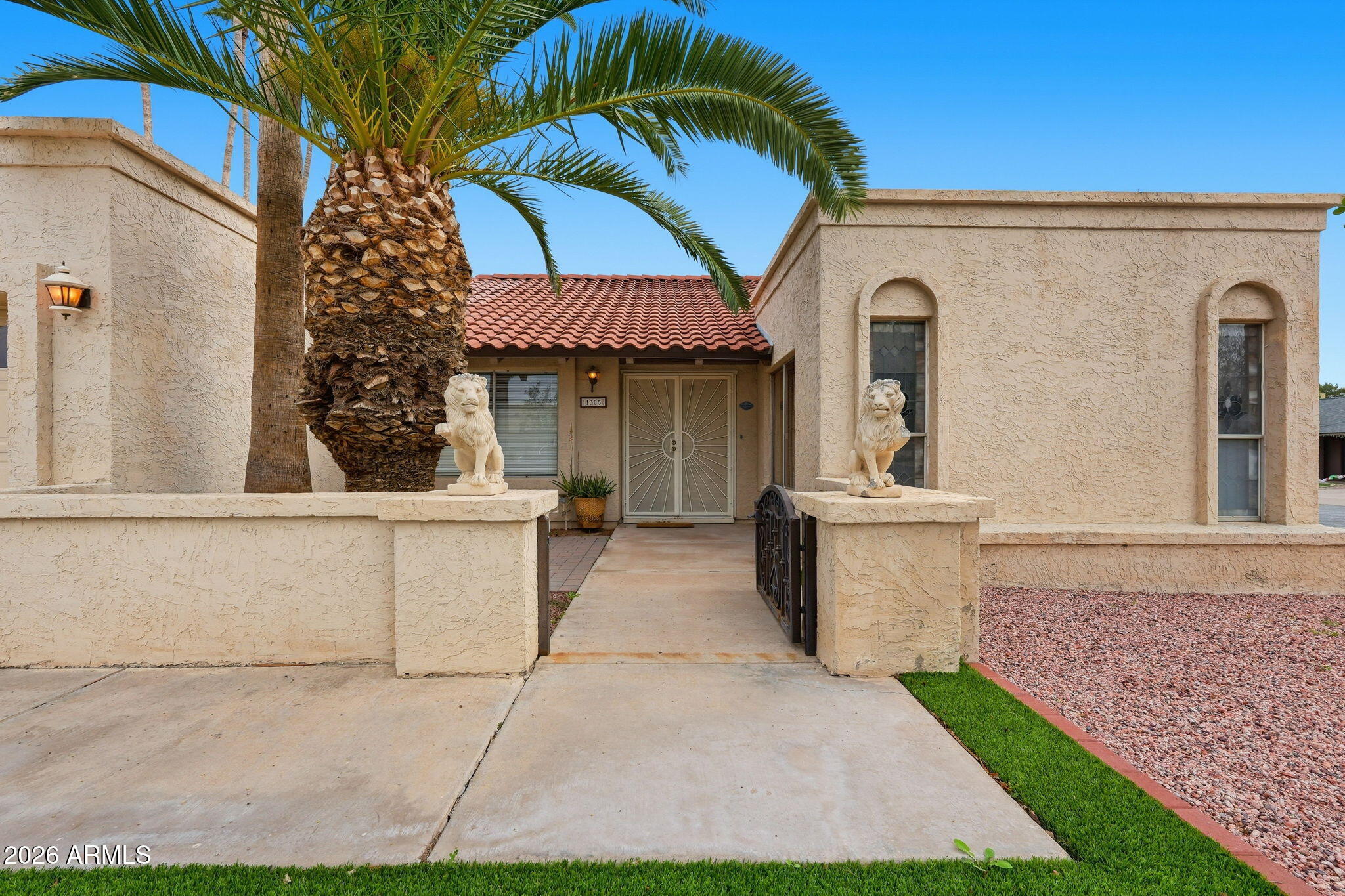 1305 North Spring Circle Mesa, AZ 85203 - Photo 2 of 28 a view of a white house with a sink and a yard