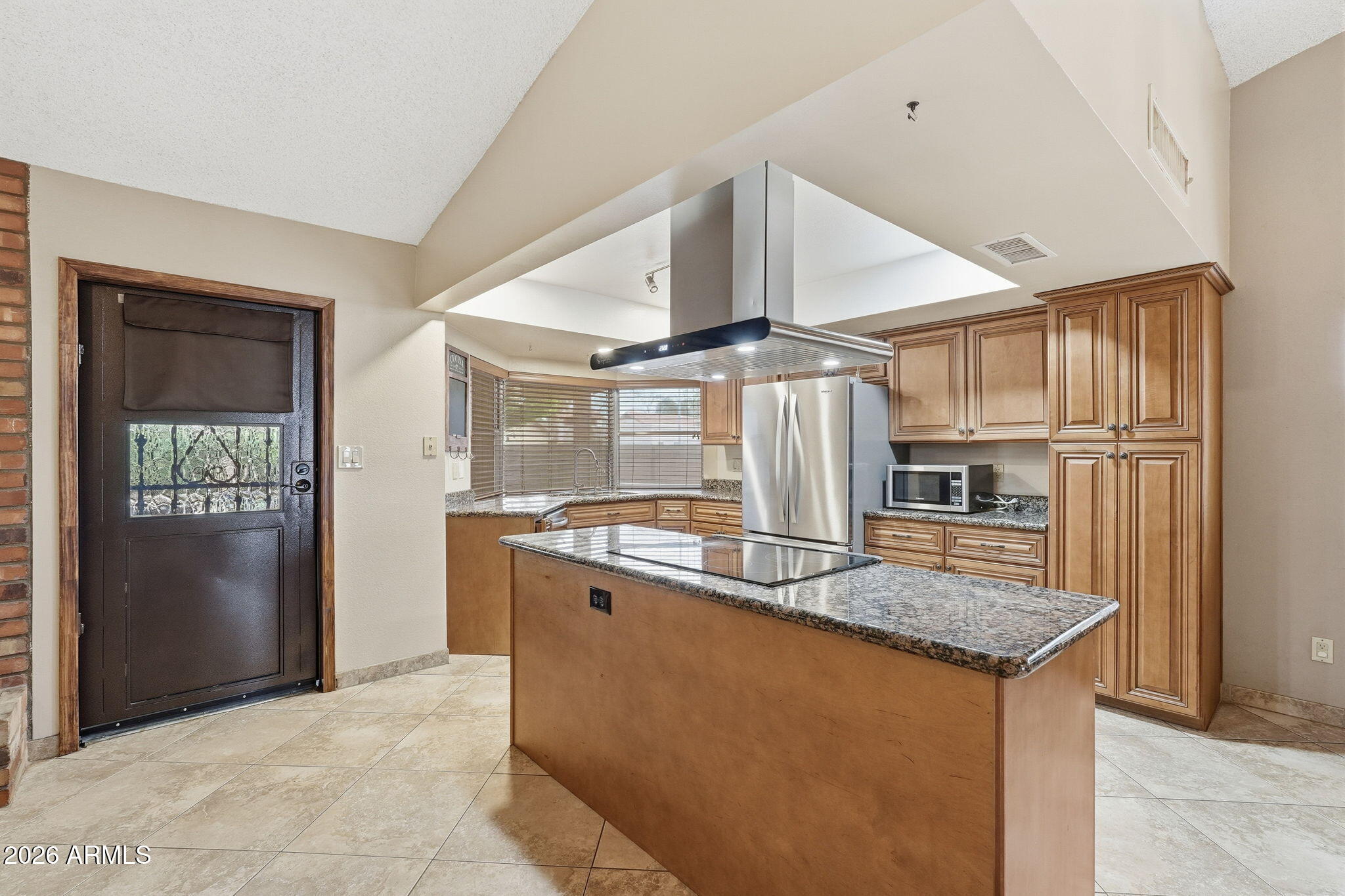 1305 North Spring Circle Mesa, AZ 85203 - Photo 4 of 28 a kitchen with granite countertop a sink and stainless steel appliances