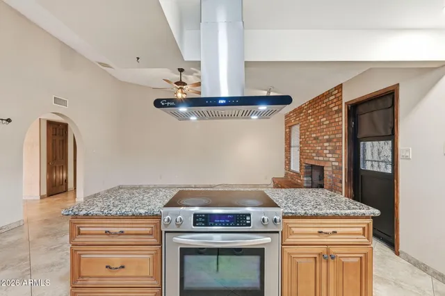 a stove top oven sitting inside of a kitchen