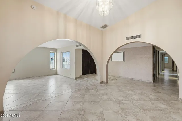 a view of empty room with ceiling fan