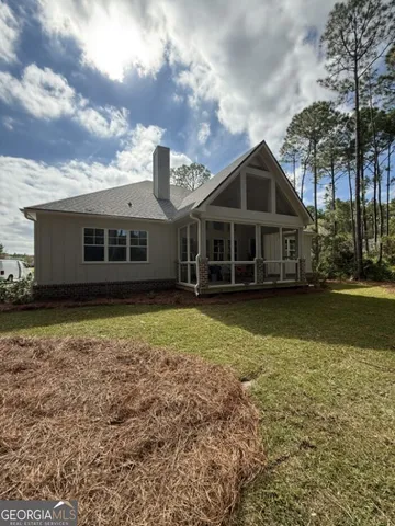 a backyard of a house with barbeque oven fire pit table and chairs