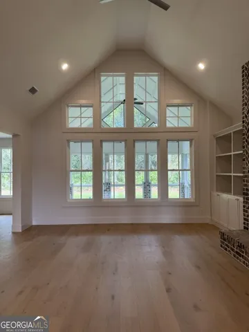 a view of an empty room with a fireplace