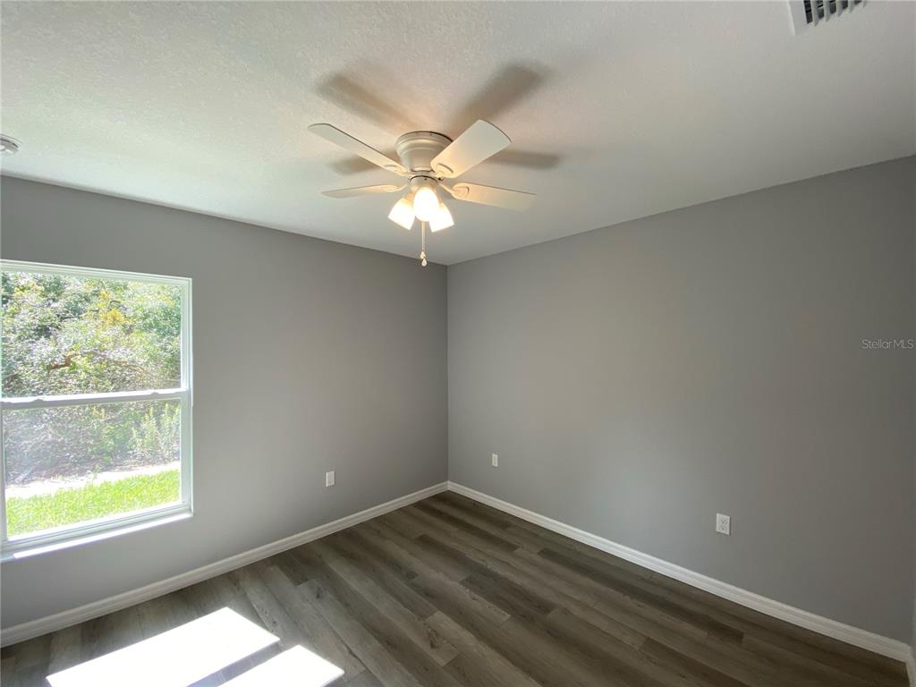 2458 Southwest 170th Loop Ocala, FL 34473 - Photo 11 of 25 an empty room with a window and a fan