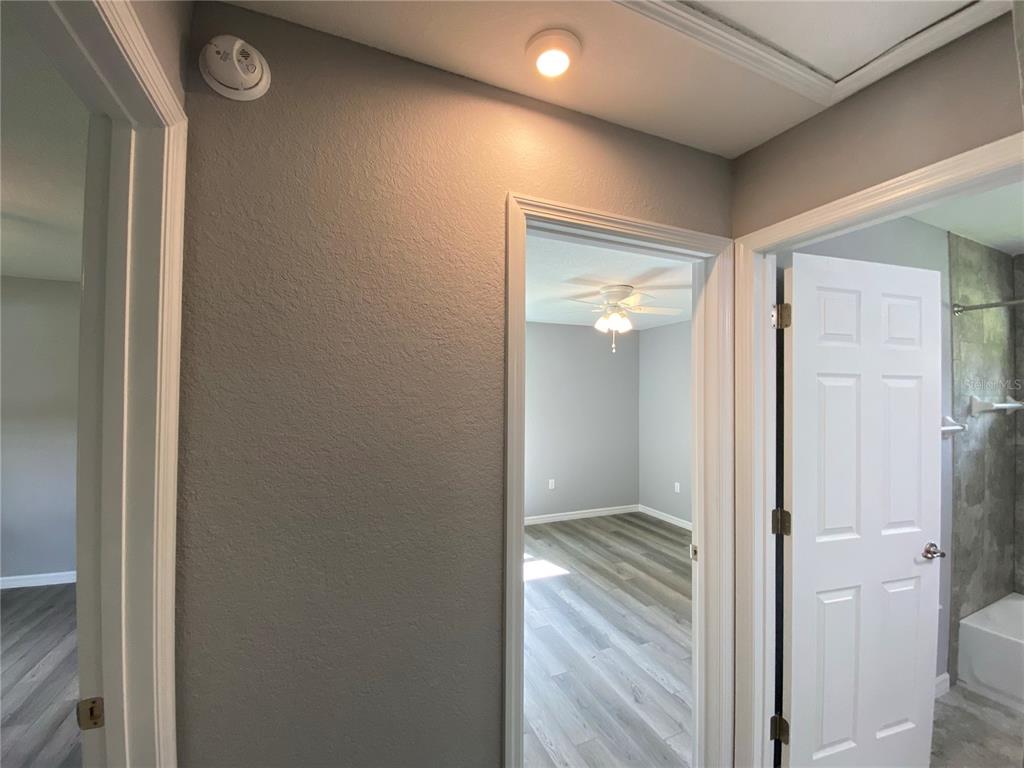 2458 Southwest 170th Loop Ocala, FL 34473 - Photo 15 of 25 a view of a hallway with wooden floor