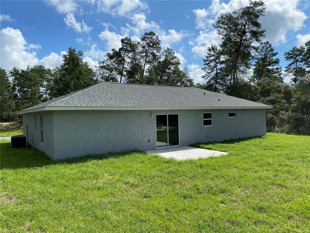 2458 Southwest 170th Loop Ocala, FL 34473 - Photo 24 of 25 a house with tree in front of it