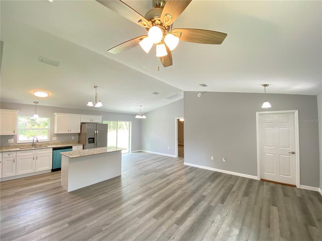 2458 Southwest 170th Loop Ocala, FL 34473 - Photo 4 of 25 an open kitchen with a refrigerator and a stove top oven