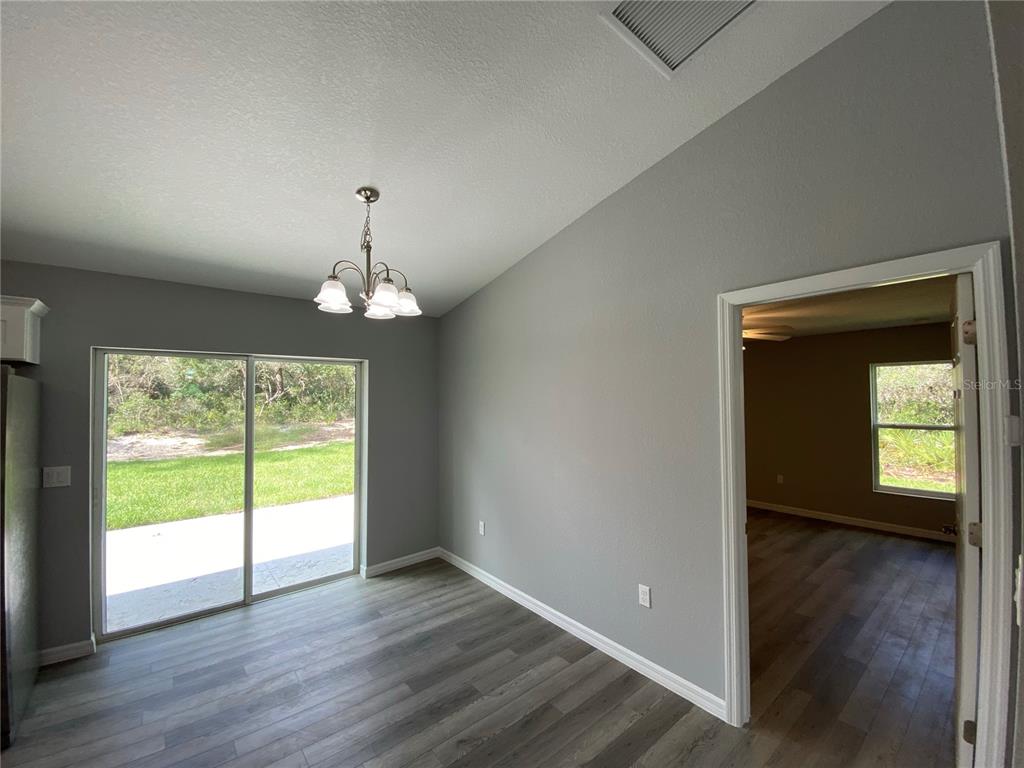 2458 Southwest 170th Loop Ocala, FL 34473 - Photo 6 of 25 a view of empty room with wooden floor and fan