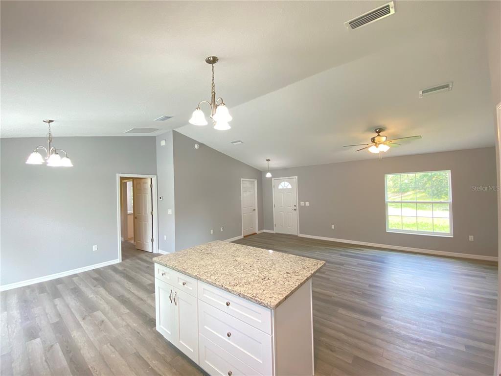 2458 Southwest 170th Loop Ocala, FL 34473 - Photo 8 of 25 an empty room with wooden floor and window