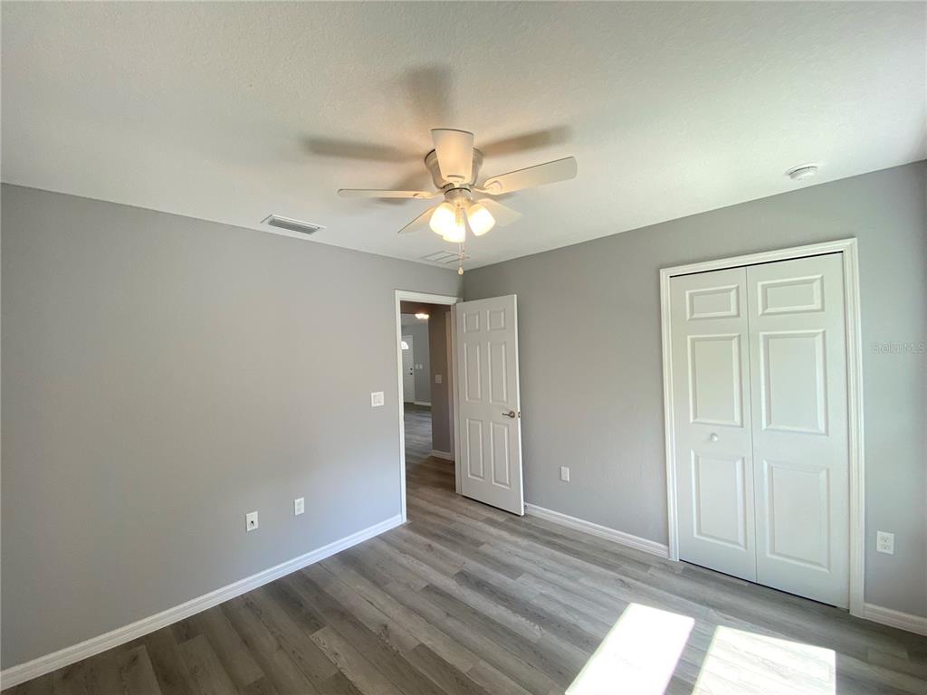 2458 Southwest 170th Loop Ocala, FL 34473 - Photo 10 of 25 wooden floor in an empty room with a window
