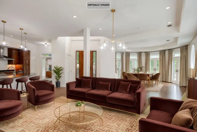 a living room with furniture kitchen and a chandelier