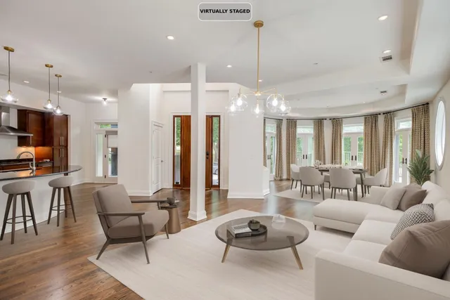 a living room with furniture kitchen and a chandelier