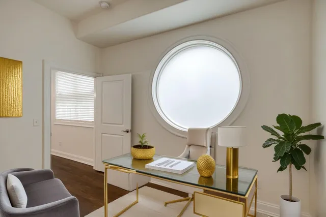 a living room with furniture and a potted plant