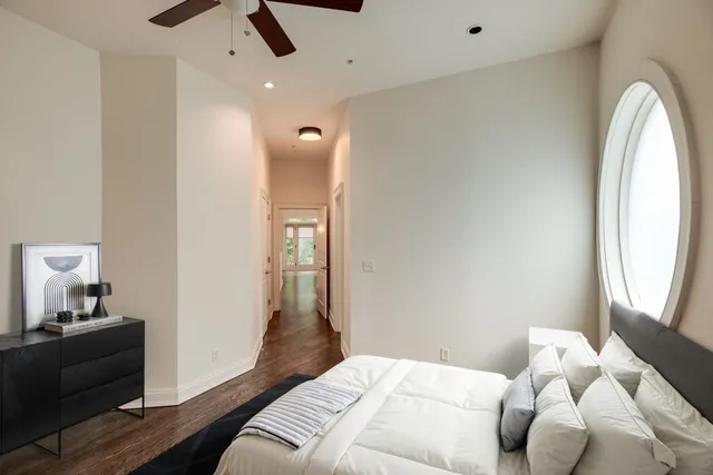 a bedroom with a bed and a mirror