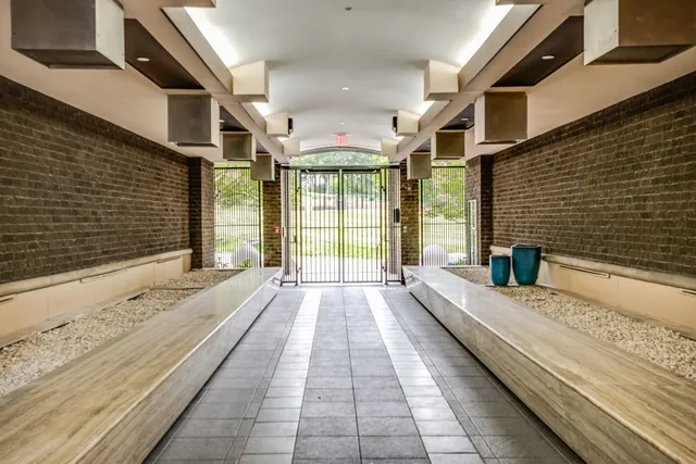 a view of an outdoor sitting area with brick walls