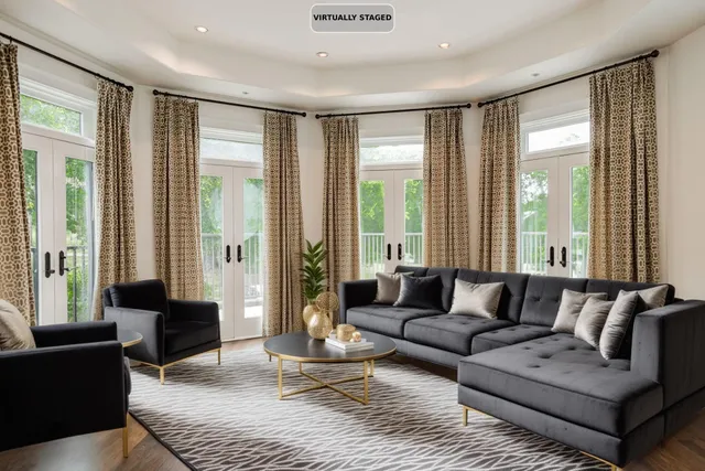 a living room with furniture and large windows