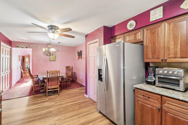 a kitchen with stainless steel appliances granite countertop a stove a sink dishwasher and a refrigerator