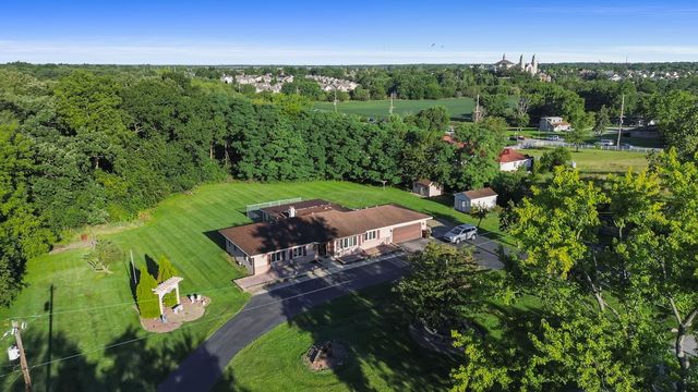 an aerial view of a house with a yard