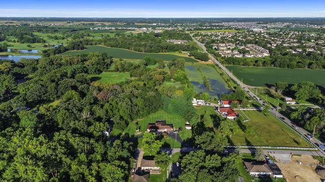 a front view of a house with a garden and yard