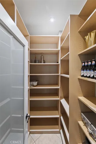 a bedroom with a bed and a dresser with mirror