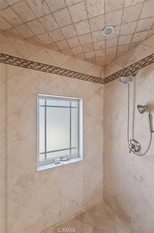 a bedroom with a bed and a mirror