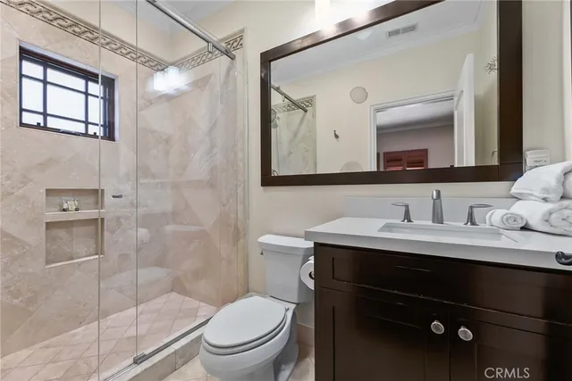 a bathroom with a granite countertop sink toilet and shower