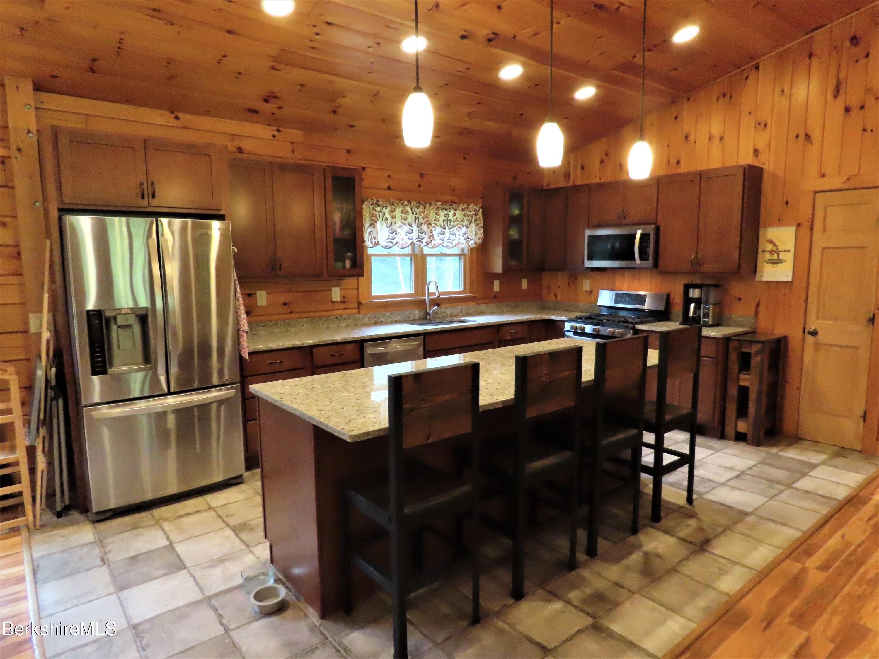 855 Jepson Road Stamford, VT 05352 - Photo 8 of 61 a kitchen with stainless steel appliances granite countertop a refrigerator a stove a sink and a microwave