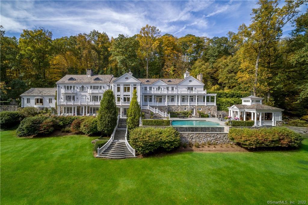 222 Lyons Plain Road Weston, CT 06883 - Photo 1 of 1 a front view of a house with a yard and trees