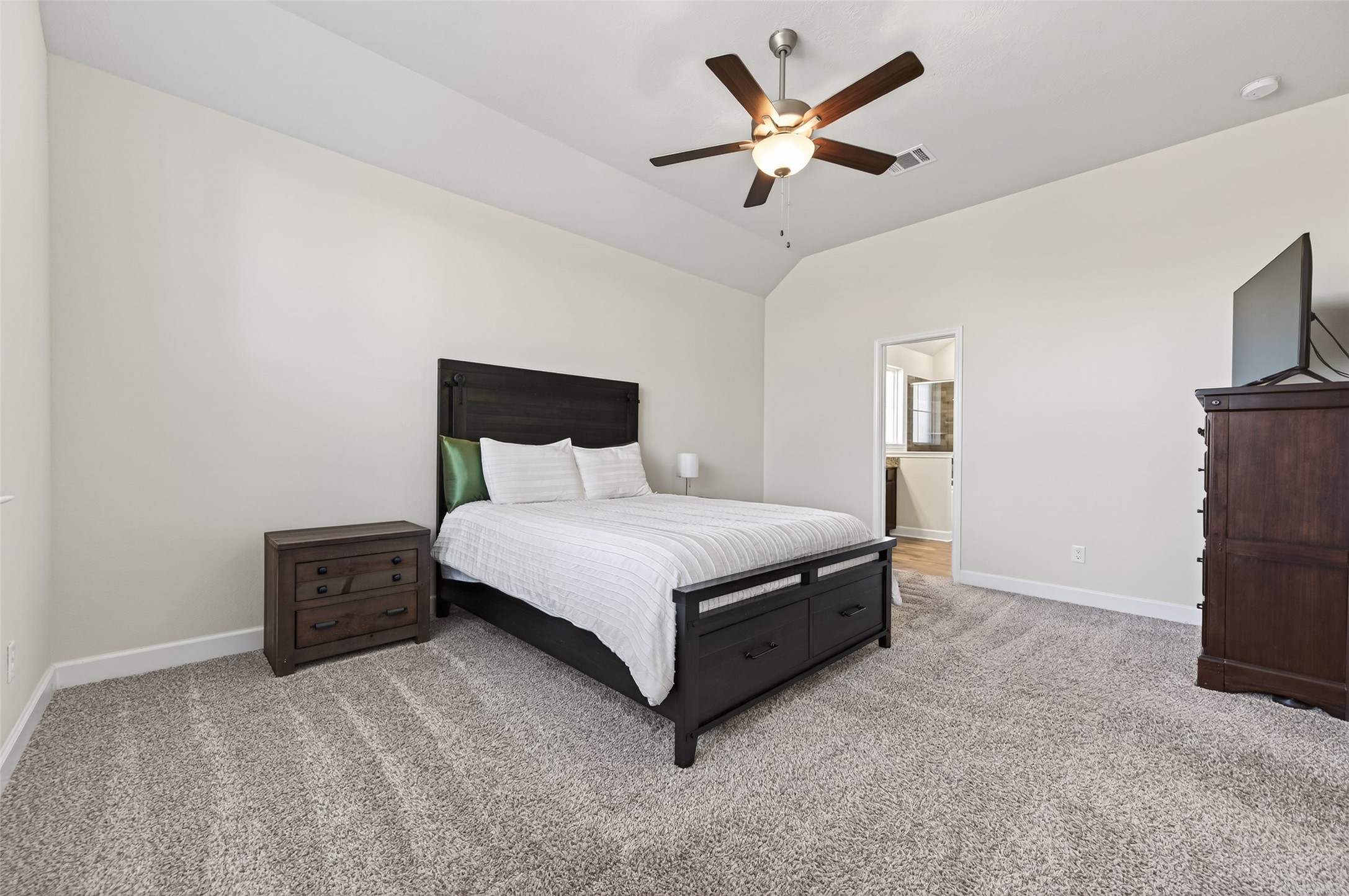 917 Farm Path Brenham, TX 77833 - Photo 21 of 43 a bedroom with a bed lamp and a fireplace
