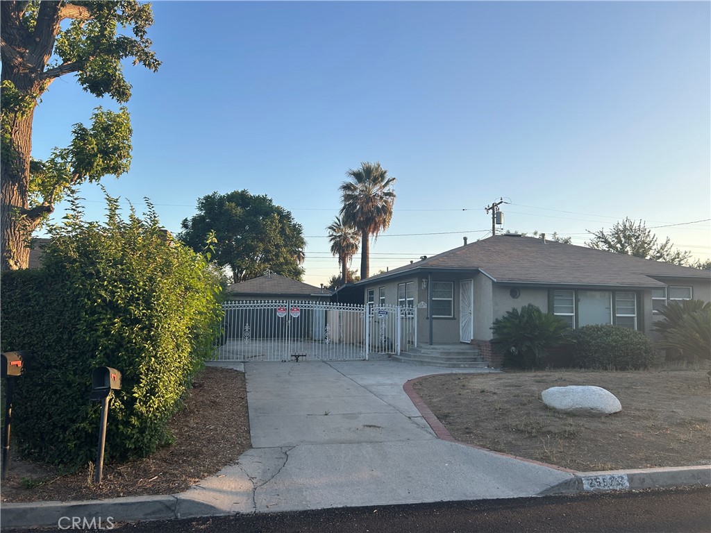 25573 18th Street San Bernardino, CA 92404 - Photo 3 of 3 a view of a house with a yard and potted plants