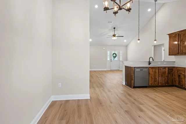 a view of a kitchen with a sink wooden floor and a window