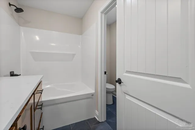 a bathroom with a bathtub sink and toilet