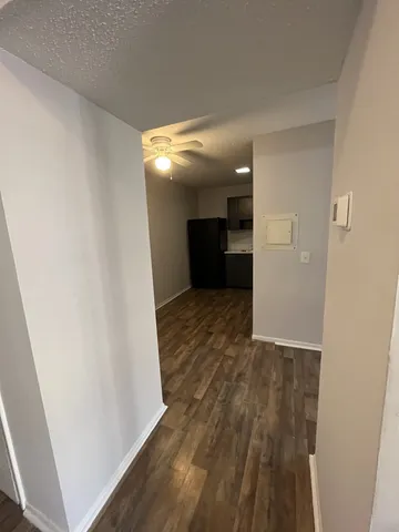 a view of a hallway with wooden floor