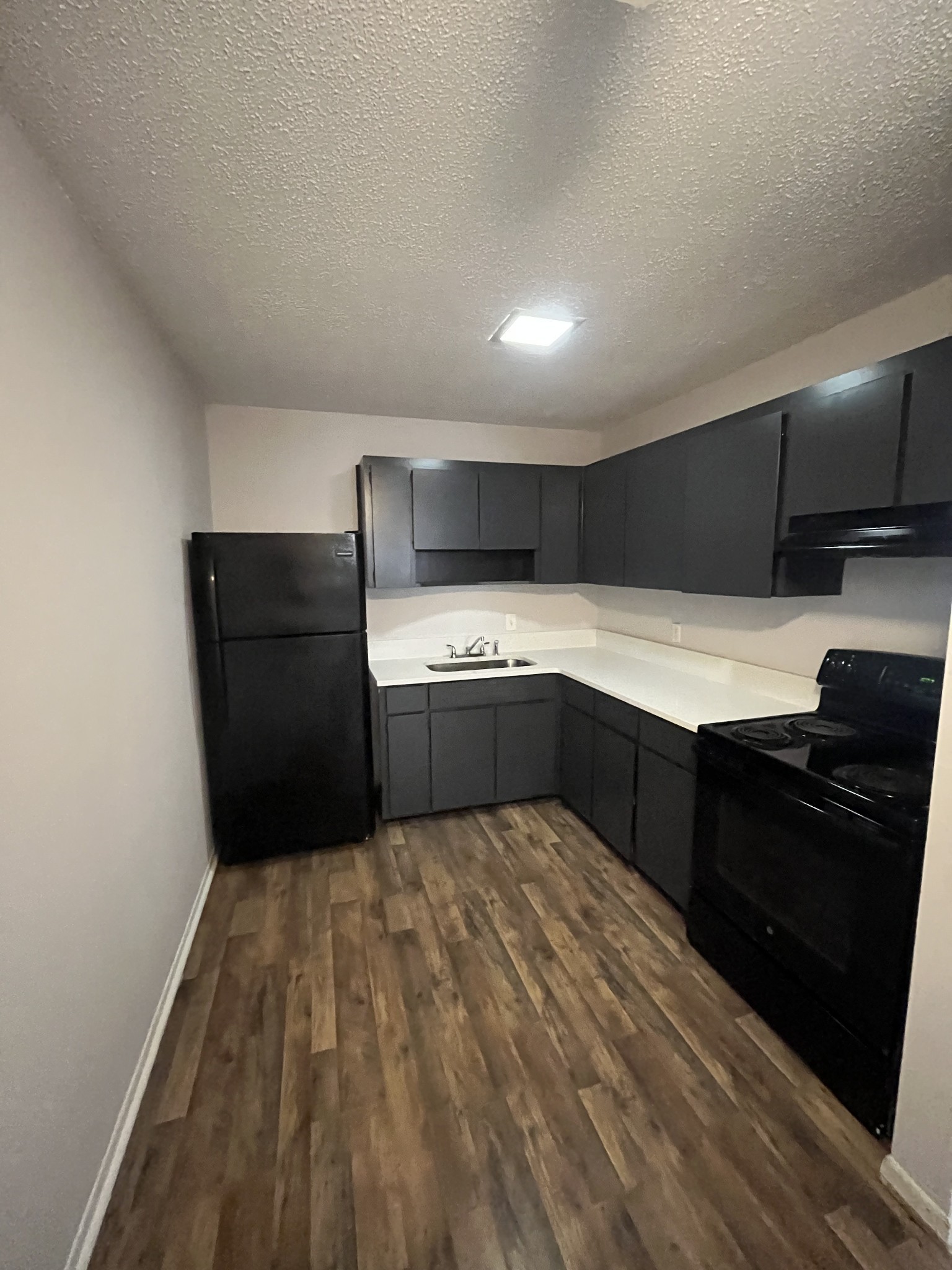 441 Harding Place, Unit E10 Nashville, TN 37211 - Photo 4 of 12 a kitchen with a refrigerator and a stove top oven