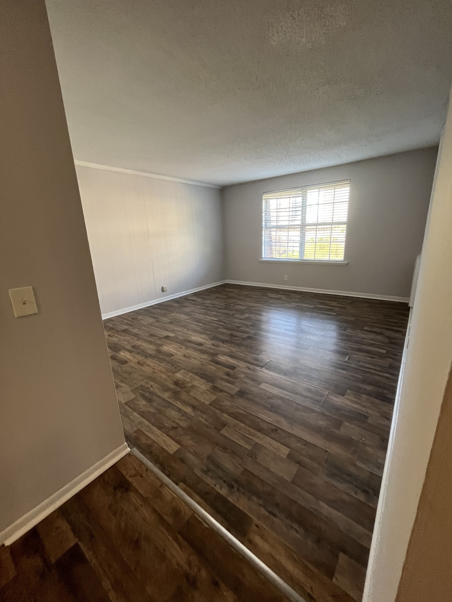 441 Harding Place, Unit E10 Nashville, TN 37211 - Photo 5 of 12 an empty room with wooden floor and windows