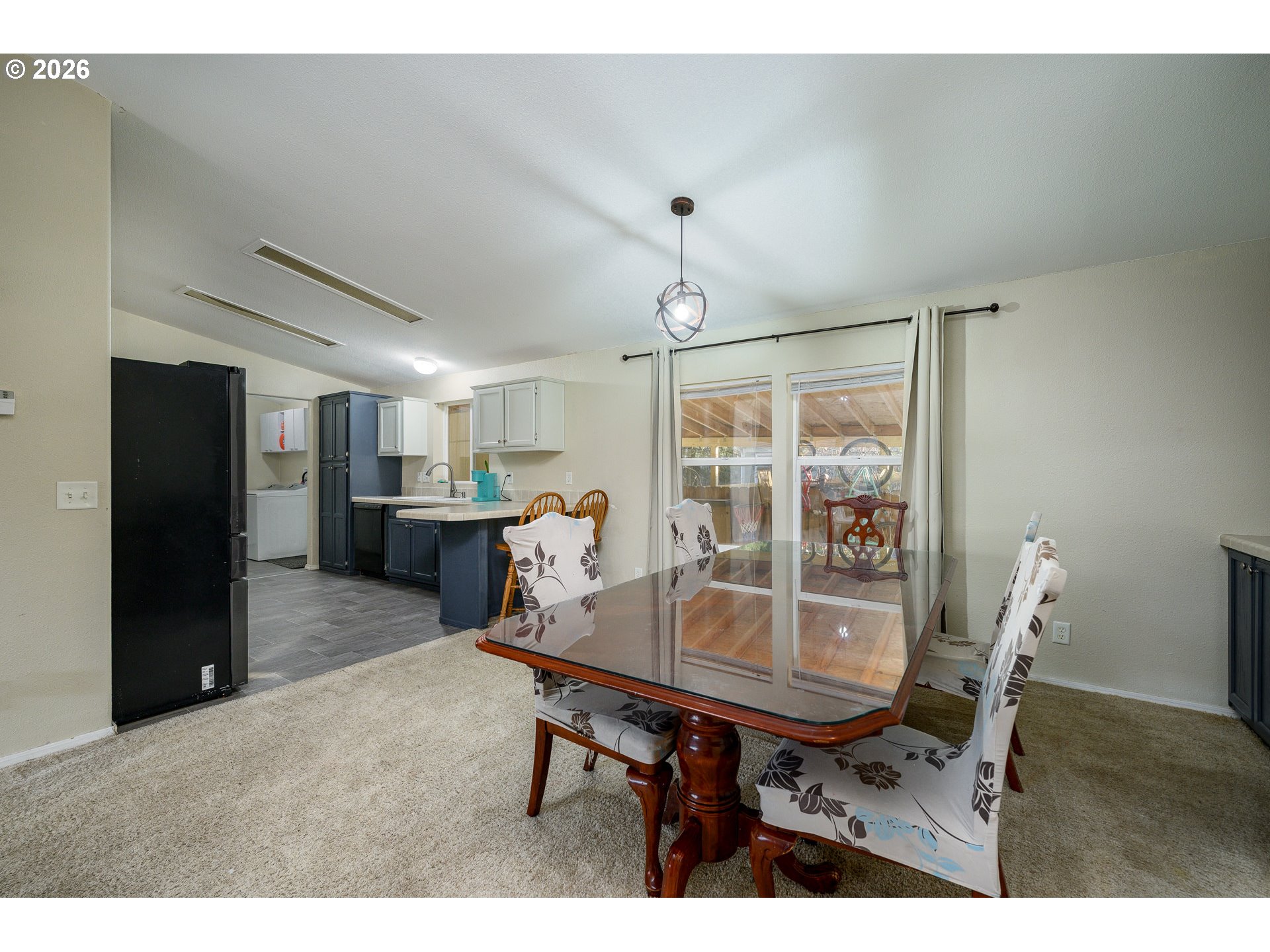 1282 3rd Street, Unit 83 Lafayette, OR 97127 - Photo 19 of 45 a view of a dining room with furniture and a chandelier