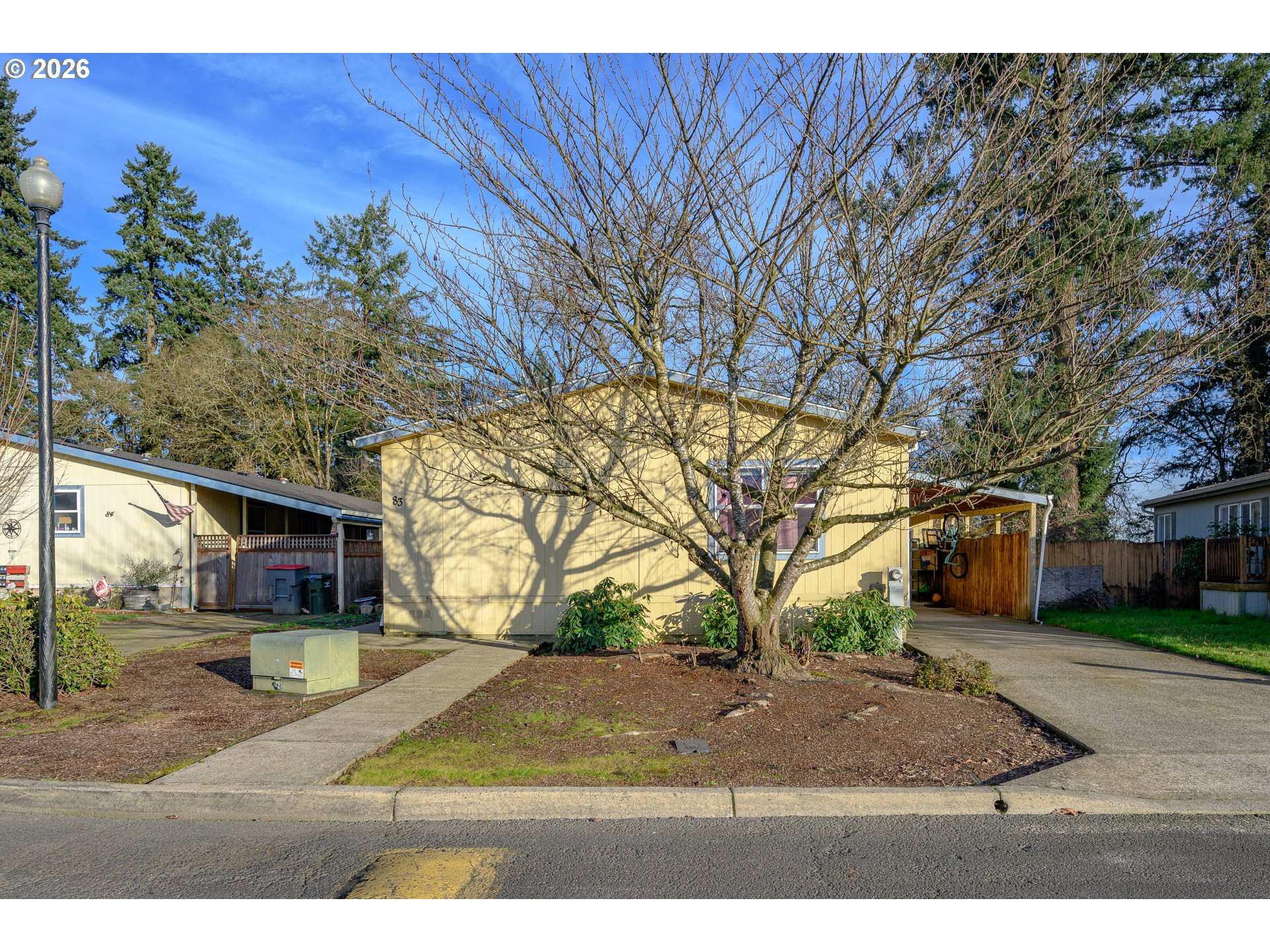 1282 3rd Street, Unit 83 Lafayette, OR 97127 - Photo 2 of 45 a view of a yard with plants and a large tree