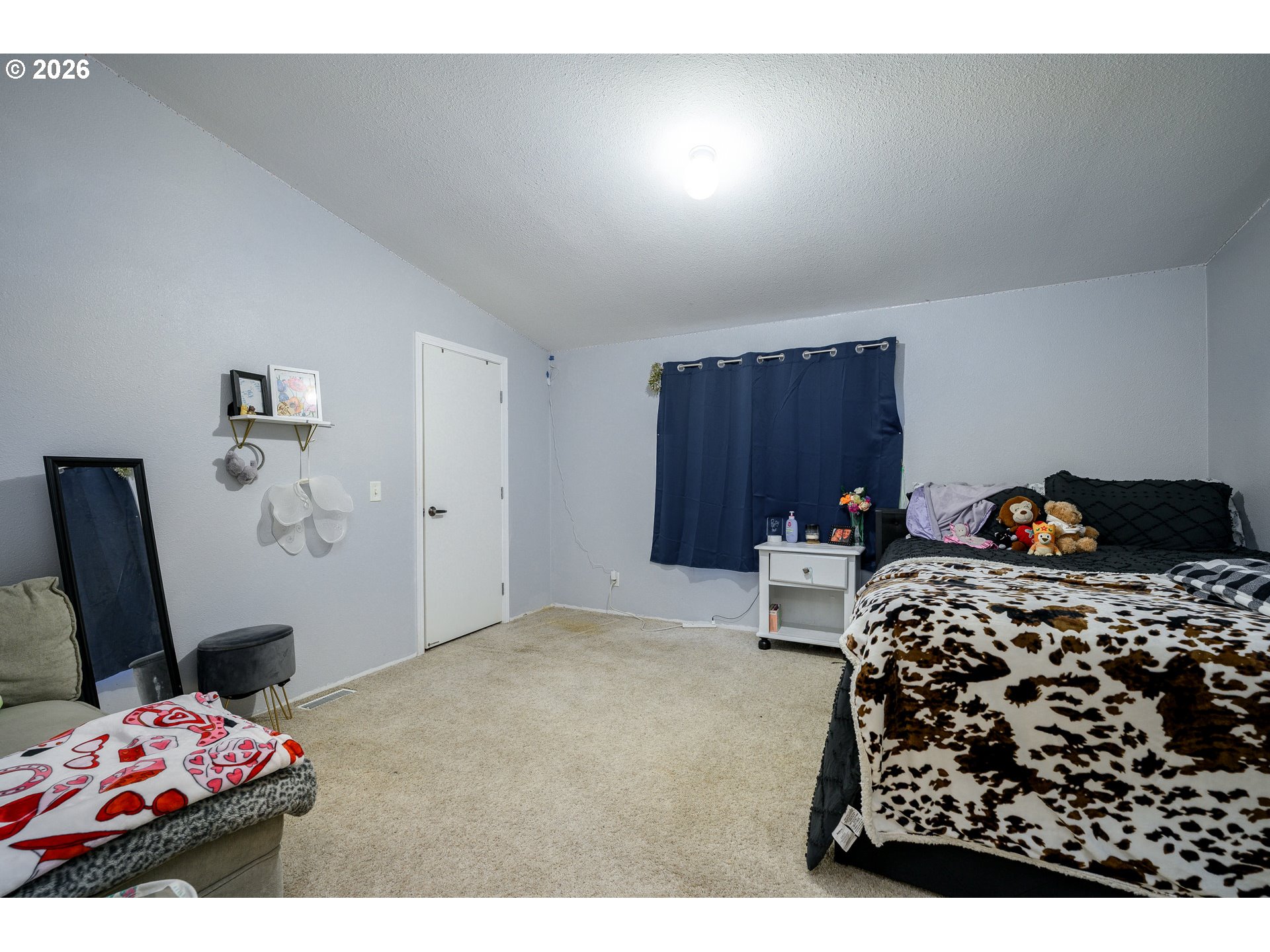 1282 3rd Street, Unit 83 Lafayette, OR 97127 - Photo 27 of 45 a bedroom with a bed and a chair