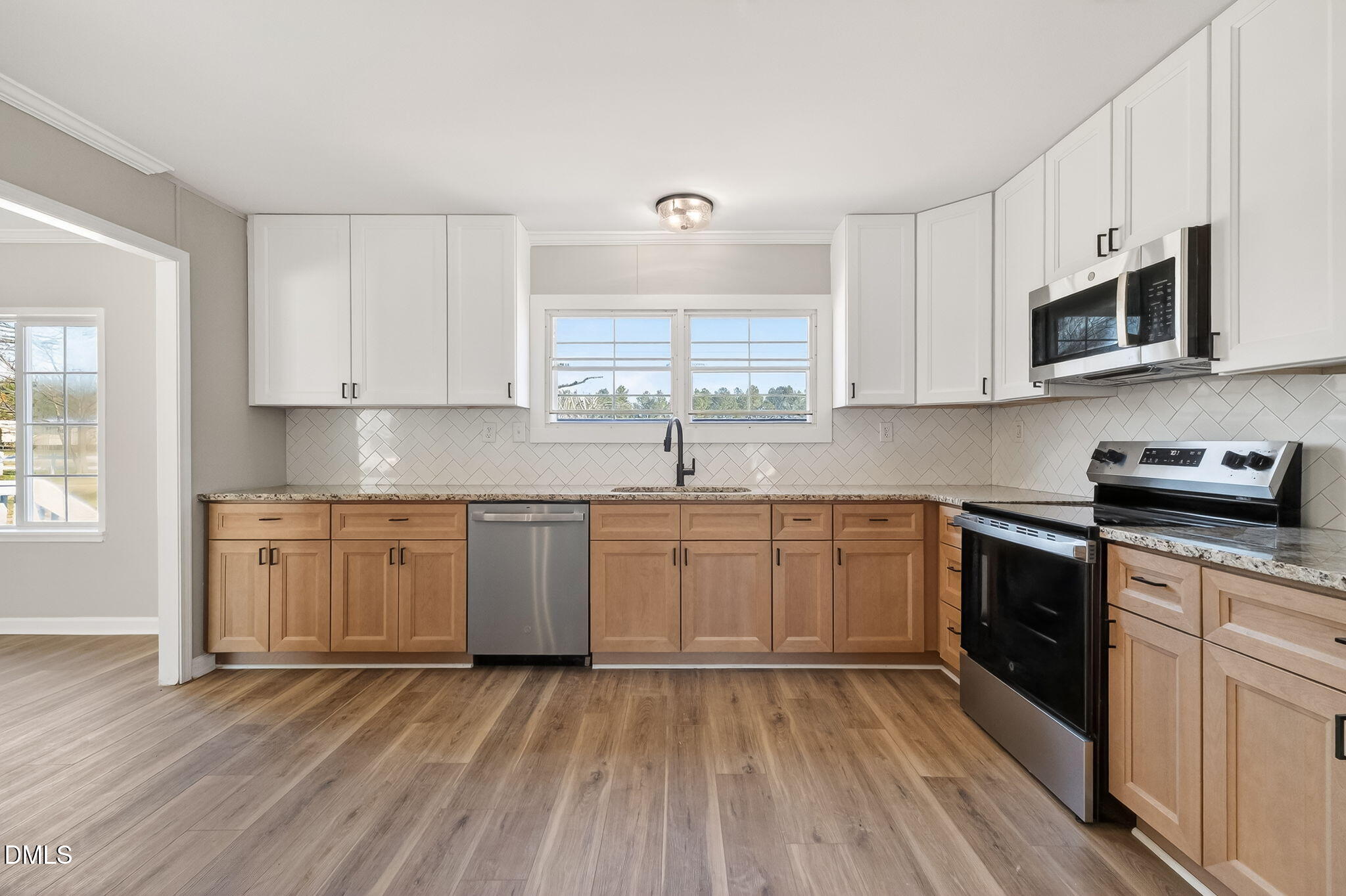 10015 Smith Road Middlesex, NC 27557 - Photo 21 of 48 a kitchen with stainless steel appliances granite countertop white cabinets sink and window
