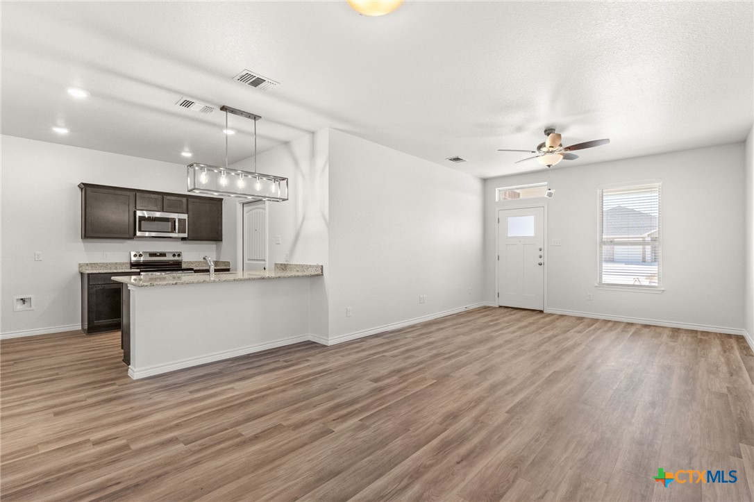 102 Levi Court, Unit B Copperas Cove, TX 76522 - Photo 2 of 9 a view of kitchen with sink microwave and stove top oven