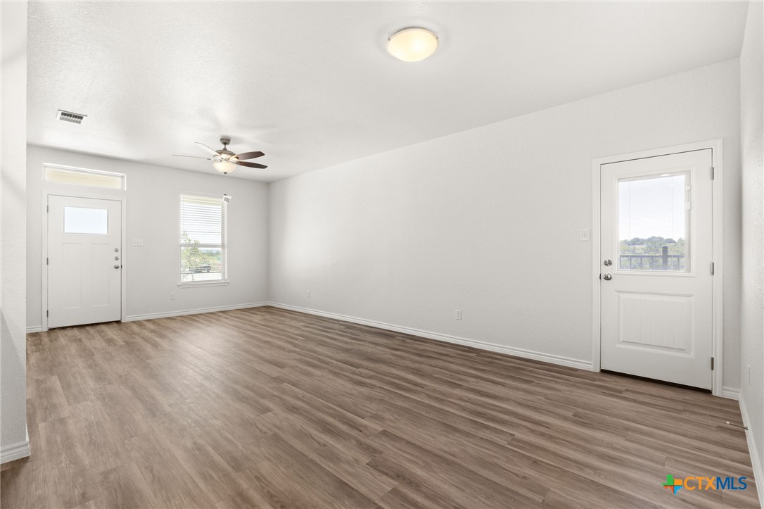 102 Levi Court, Unit B Copperas Cove, TX 76522 - Photo 3 of 9 an empty room with wooden floor and windows