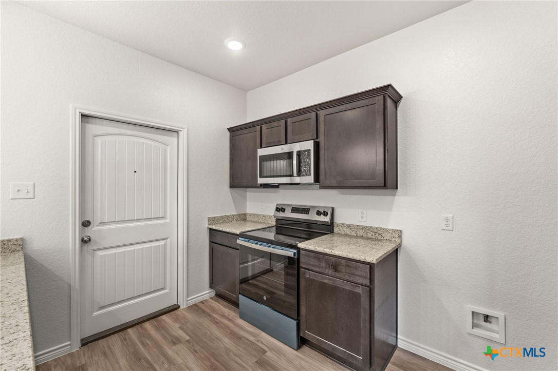 102 Levi Court, Unit B Copperas Cove, TX 76522 - Photo 4 of 9 a kitchen with a refrigerator sink and microwave