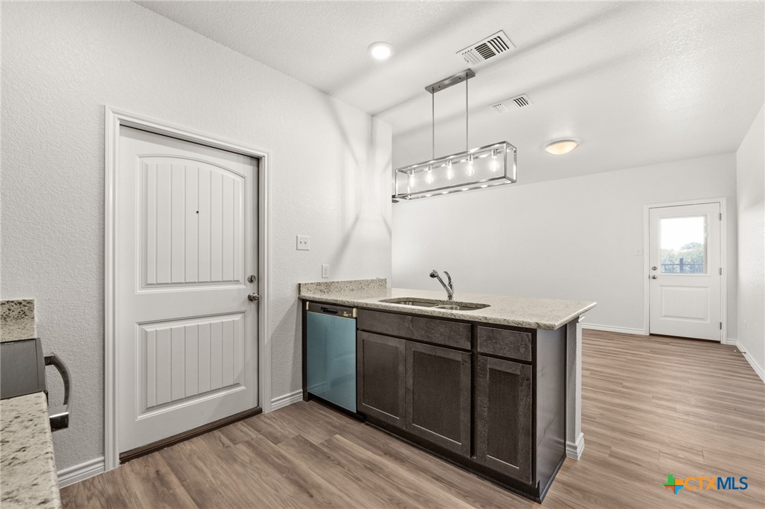 102 Levi Court, Unit B Copperas Cove, TX 76522 - Photo 5 of 9 a view of a kitchen sink and wooden floor